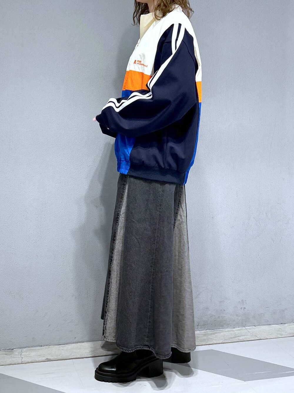 グレー系のTシャツ/カットソー、ホワイト系のブルゾン、ブラック系のデニムスカートを着用したレディースの春コーディネートの3枚目の写真