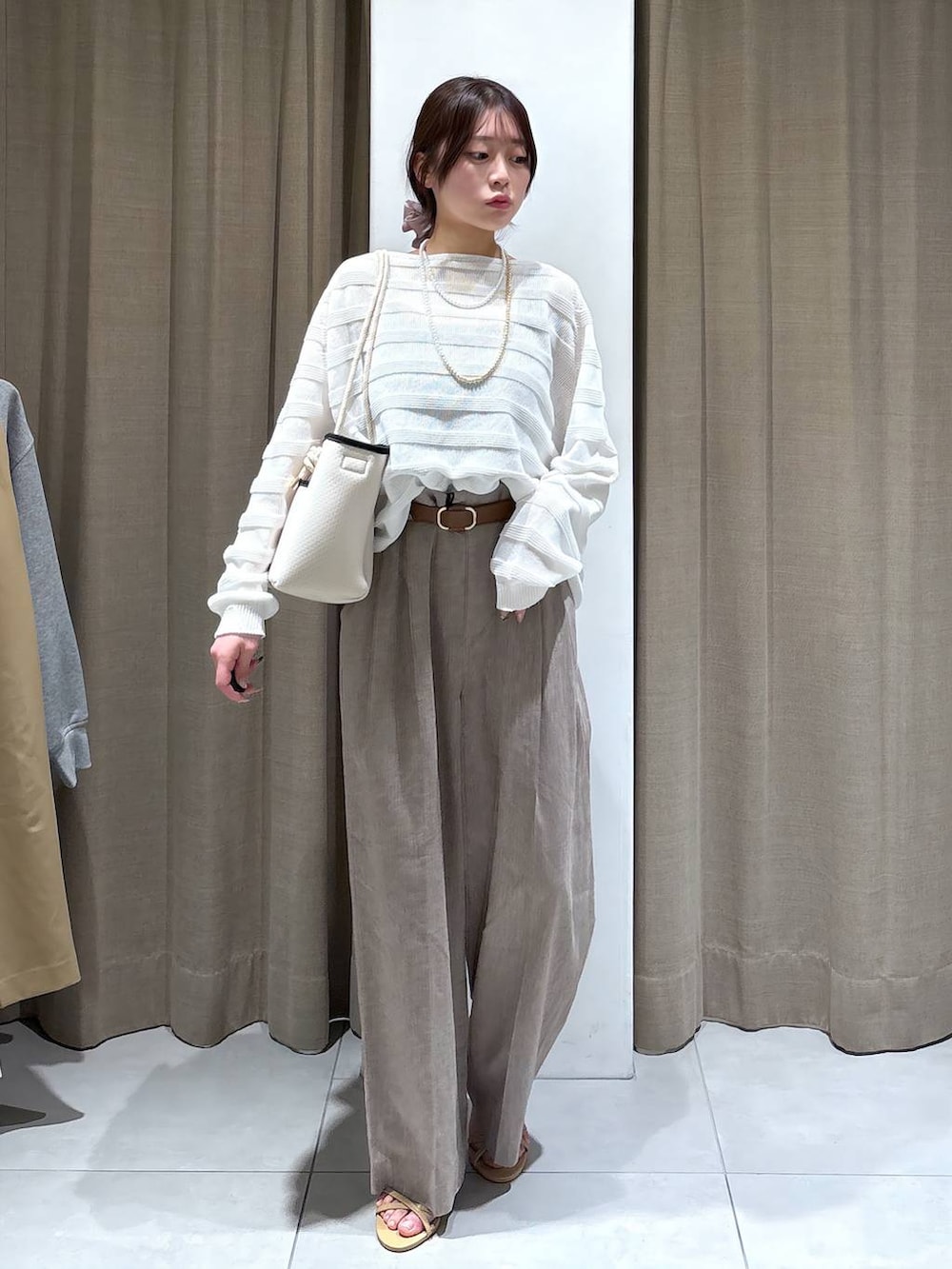 ブラック系のタンクトップ、ホワイト系のニット/セーター、ベージュ系のその他パンツを着用したレディースの春コーディネートの5枚目の写真