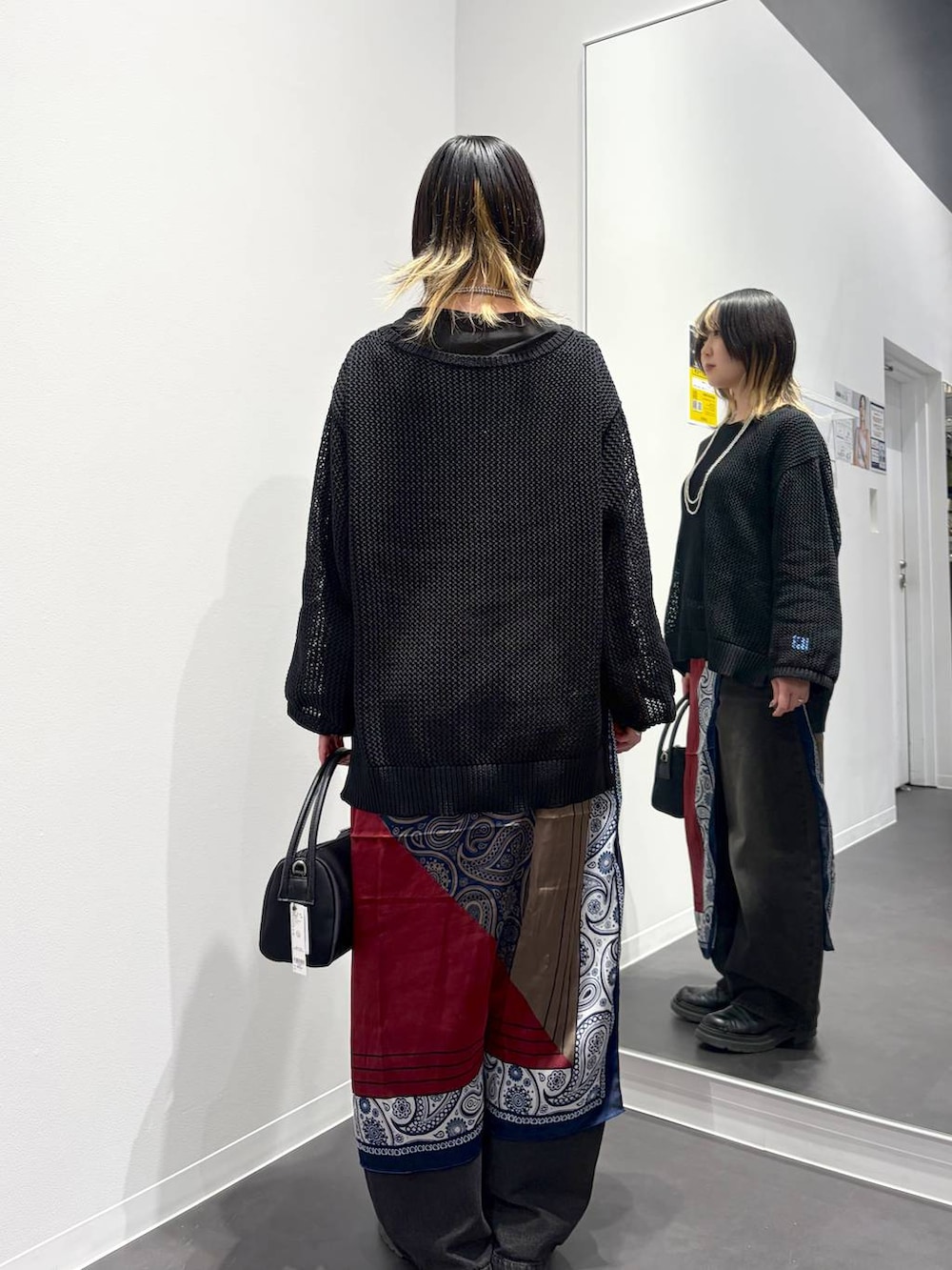 ブラック系のデニムパンツ、ブラック系のTシャツ/カットソー、ブラック系のニット/セーターを着用したレディースの春コーディネートの3枚目の写真