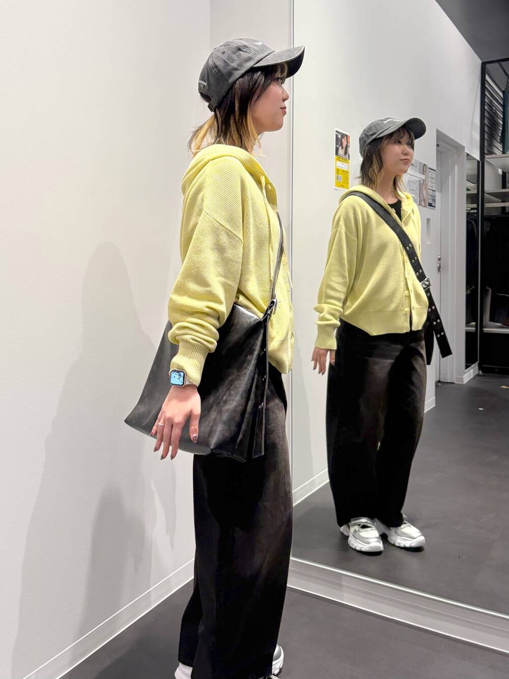 ブラック系のデニムパンツ、ブラック系のTシャツ/カットソー、ブラック系のショルダーバッグを着用したレディースの春コーディネートの4枚目の写真