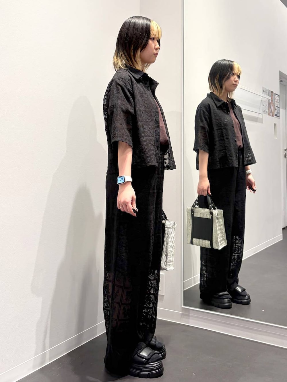 ホワイト系のショルダーバッグ、ブラック系のサンダル、ブラウン系のTシャツ/カットソーを着用したレディースの春コーディネートの4枚目の写真