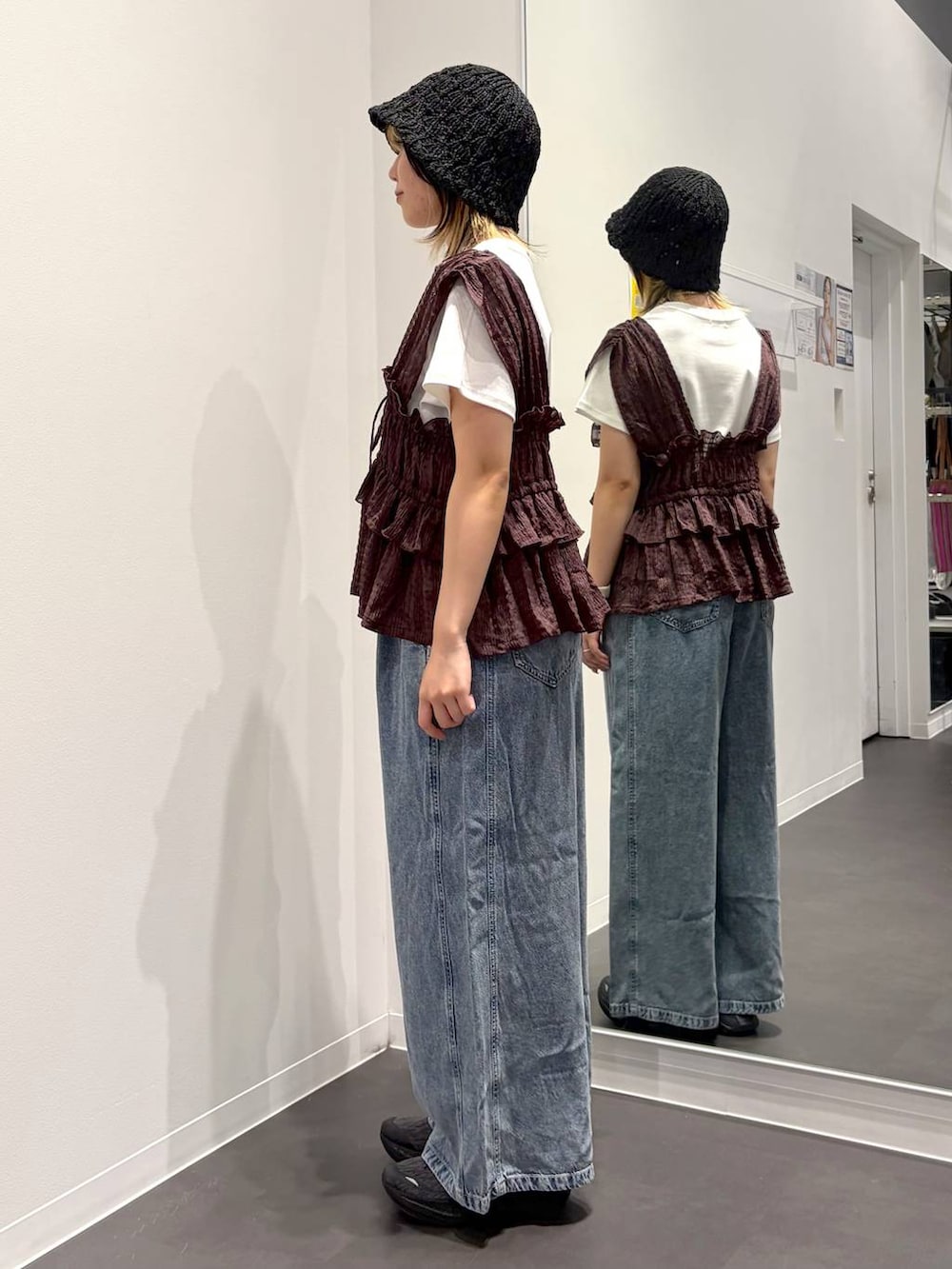 ブラウン系のベスト、ホワイト系のTシャツ/カットソー、ブルー系のデニムパンツを着用したレディースの夏コーディネートの2枚目の写真