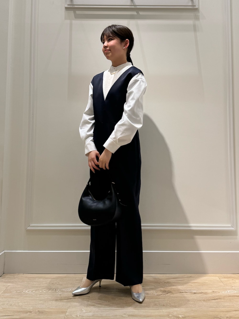 ブルー系のつなぎ/オールインワン、ホワイト系のシャツ/ブラウス、シルバー系のパンプスを着用したレディースの冬コーディネートの2枚目の写真