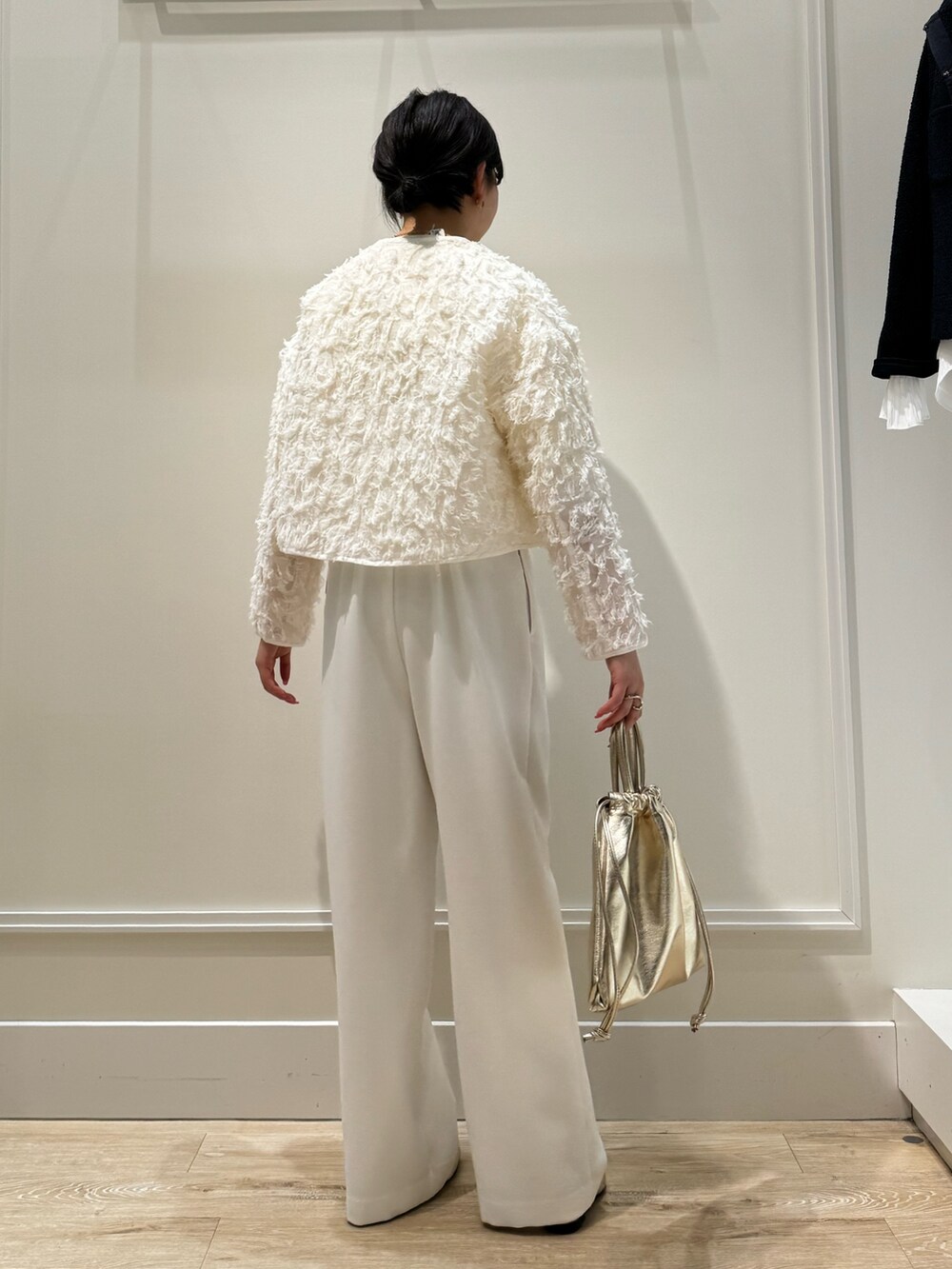 ホワイト系のつなぎ/オールインワン、ゴールド系のショルダーバッグ、ベージュ系のニット/セーターを着用したレディースの春コーディネートの5枚目の写真