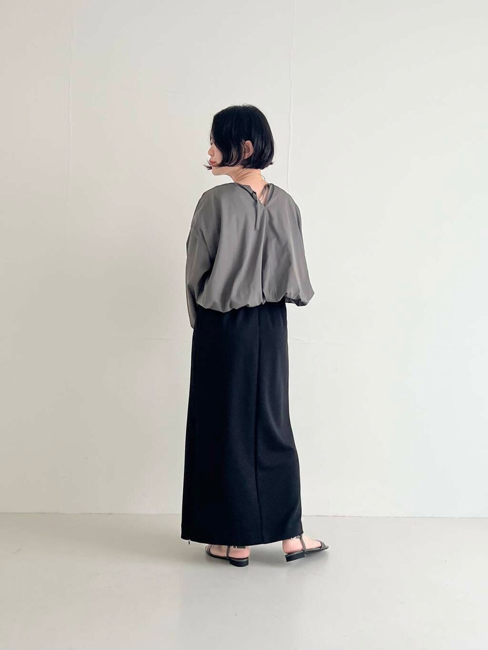 ブラック系のスカート、グレー系のシャツ/ブラウス、ブラック系のハンドバッグを着用したレディースの夏コーディネートの3枚目の写真