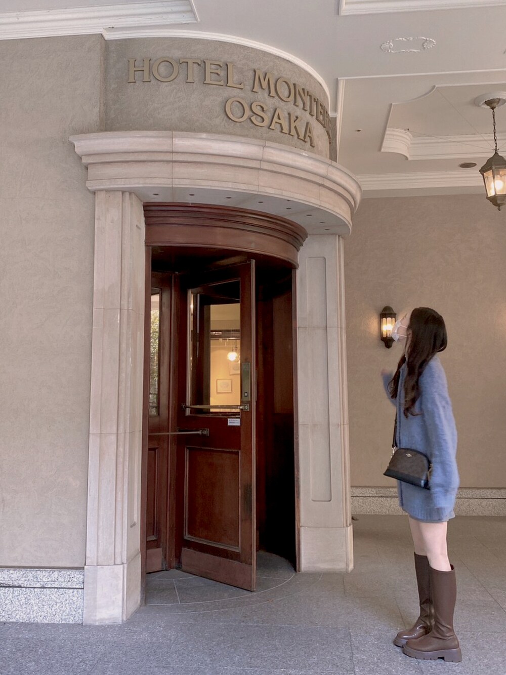 ブルー系のカーディガン/ボレロ、ホワイト系のシャツ/ブラウス、グレー系のパンツを着用したレディースの秋コーディネートの3枚目の写真