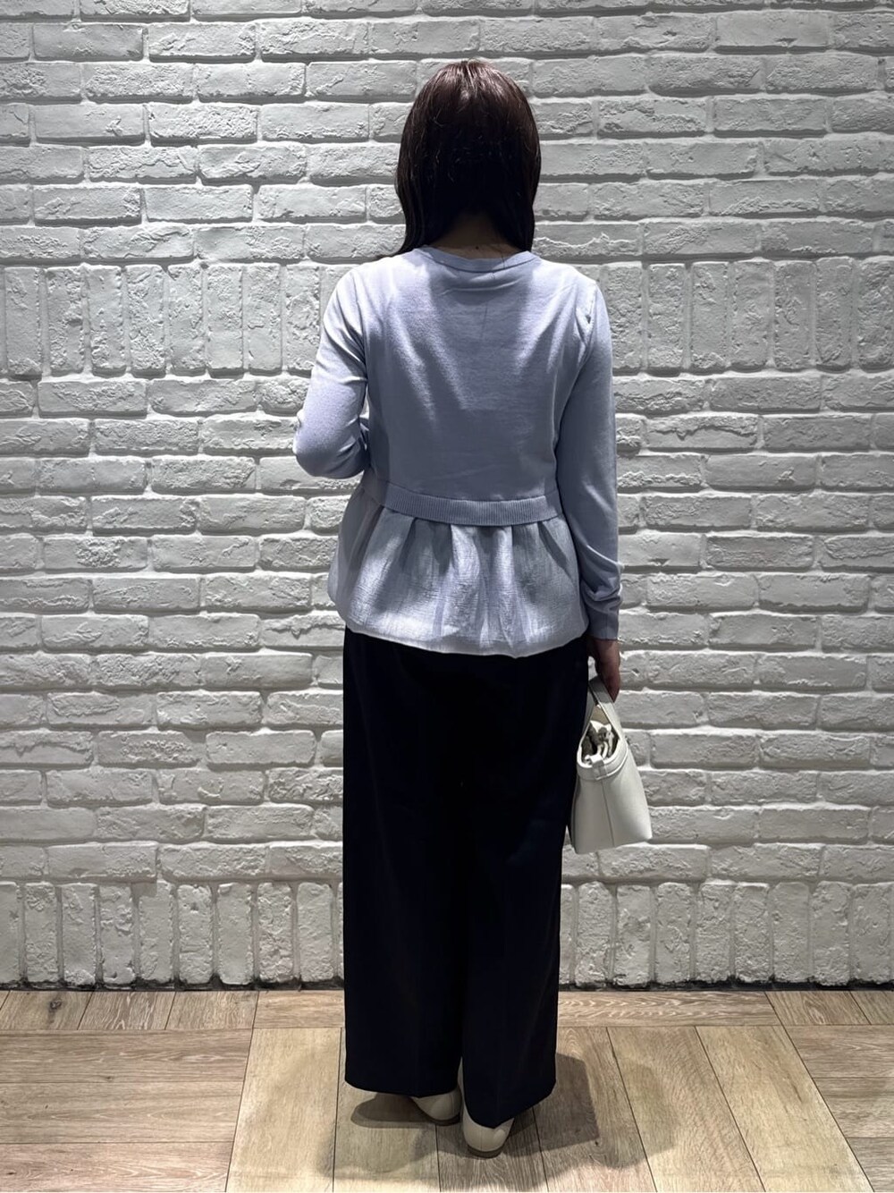 ブルー系のカーディガン/ボレロ、ブラック系のその他パンツ、ホワイト系のショルダーバッグを着用したレディースの春コーディネートの3枚目の写真
