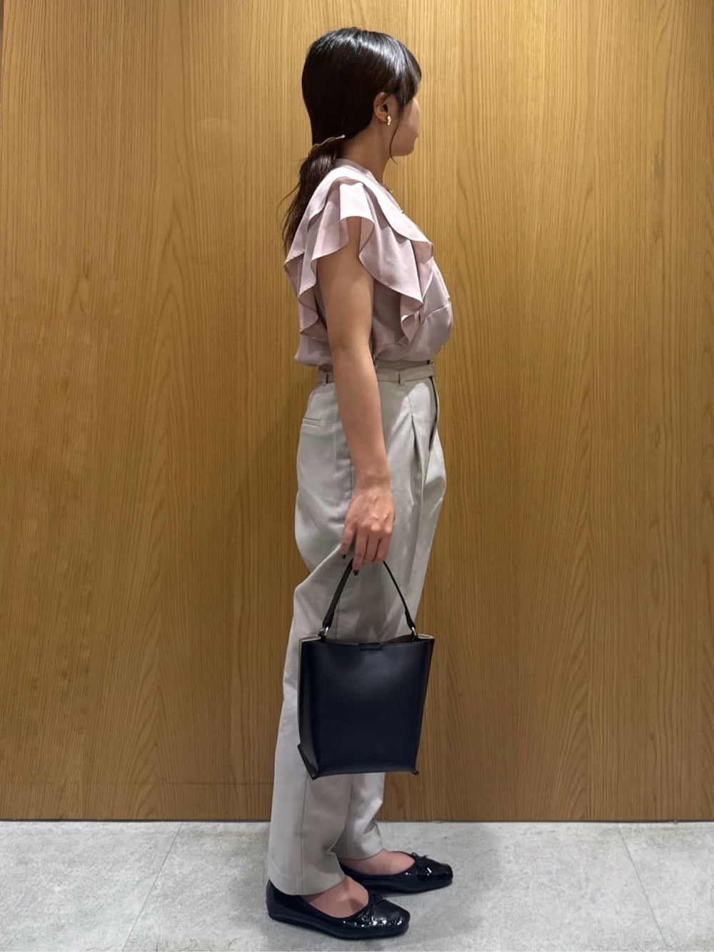 ピンク系のシャツ/ブラウス、ベージュ系のその他パンツ、ブラック系のショルダーバッグを着用したレディースの夏コーディネートの2枚目の写真