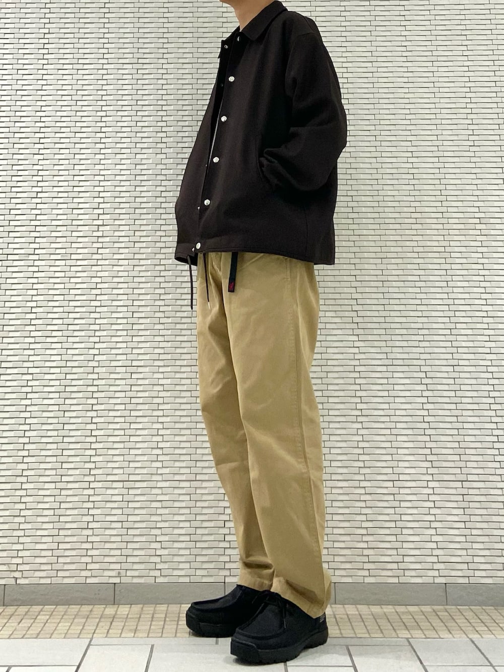 ブラウン系のセットアップ、ブラウン系のニット/セーター、ベージュ系のその他パンツを着用したメンズの秋コーディネートの3枚目の写真