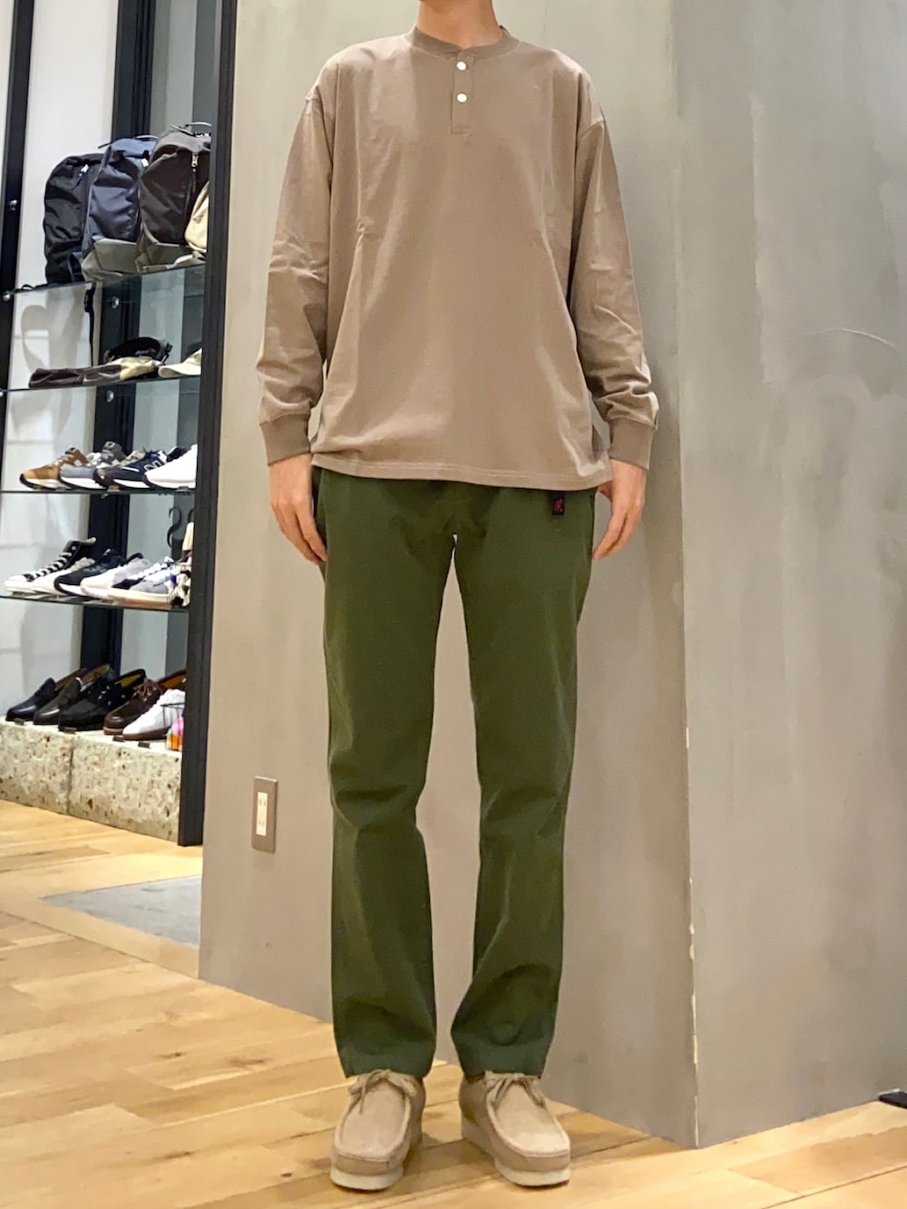 ベージュ系のその他アウター、グリーン系のその他パンツ、ブラウン系のTシャツ/カットソーを着用したメンズの春コーディネートの2枚目の写真