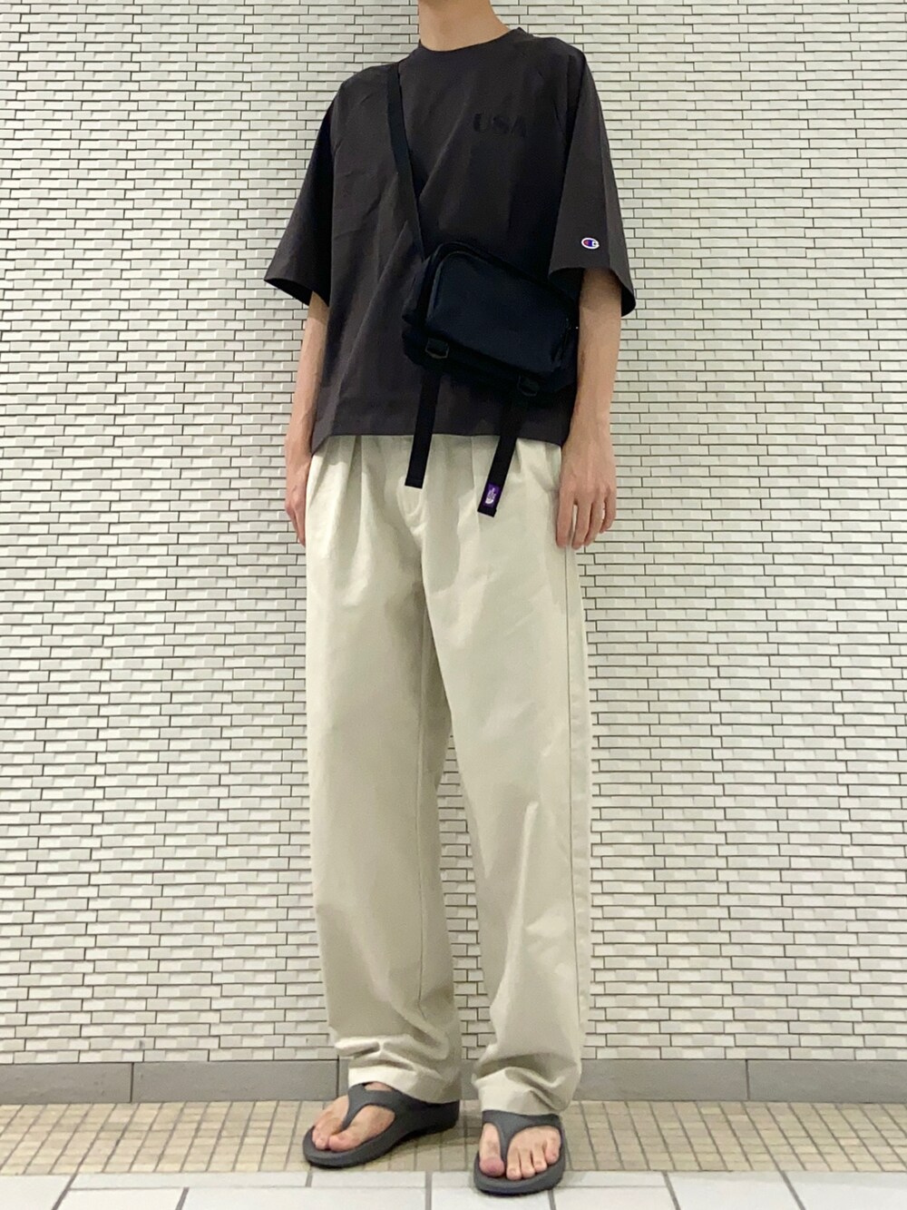 ブラック系のTシャツ/カットソー、ホワイト系のその他パンツ、グレー系のサンダルを着用したメンズの春コーディネートの2枚目の写真