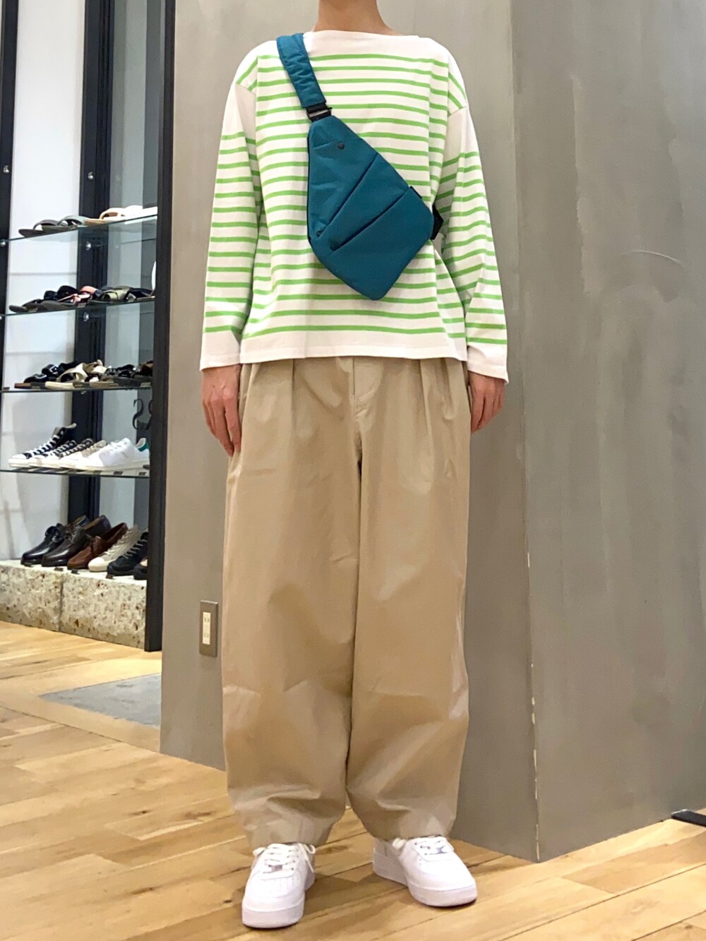 グリーン系のTシャツ/カットソー、グリーン系のショルダーバッグ、ベージュ系のその他パンツを着用したメンズの春コーディネートの4枚目の写真