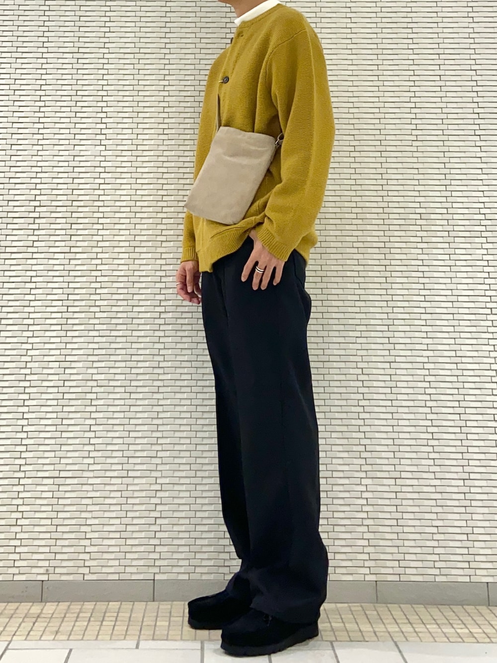 イエロー系のカーディガン/ボレロ、ベージュ系のショルダーバッグ、ホワイト系のTシャツ/カットソーを着用したメンズの秋コーディネートの2枚目の写真