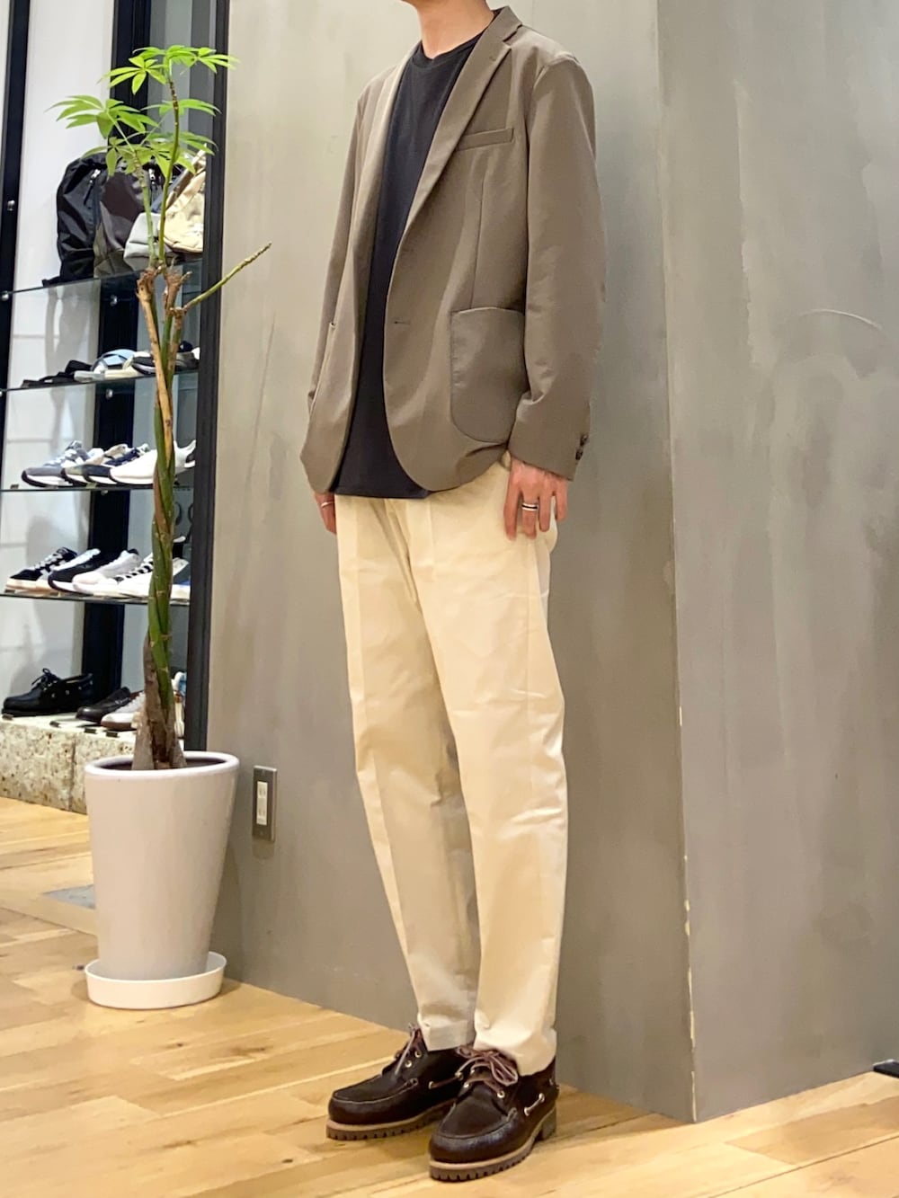 ブラウン系のスーツジャケット、ブラック系のTシャツ/カットソー、ホワイト系のその他パンツを着用したメンズの春コーディネートの3枚目の写真