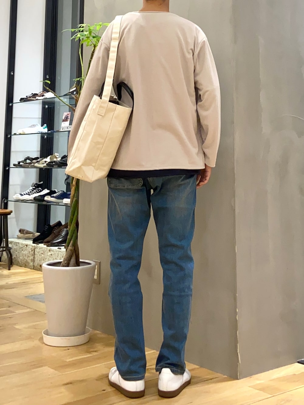 グレー系のカーディガン/ボレロ、ブルー系のTシャツ/カットソー、ホワイト系のスニーカーを着用したメンズの秋コーディネートの3枚目の写真