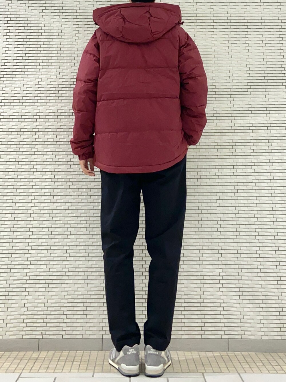 レッド系のダウンジャケット/コート、ブラック系のチノパンツ、グレー系のスニーカーを着用したメンズの秋コーディネートの3枚目の写真