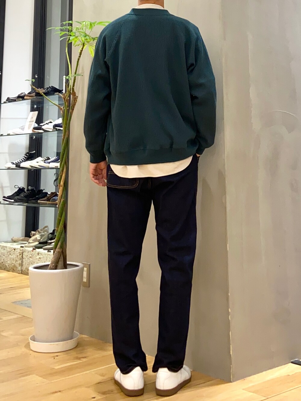 グリーン系のカーディガン/ボレロ、ベージュ系のシャツ/ブラウス、ホワイト系のスニーカーを着用したメンズの秋コーディネートの3枚目の写真
