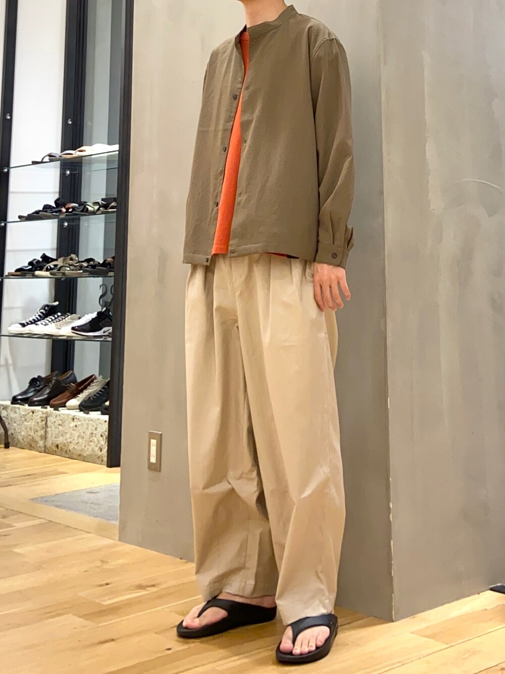 グリーン系のブルゾン、レッド系のTシャツ/カットソー、ベージュ系のその他パンツを着用したメンズの夏コーディネートの3枚目の写真