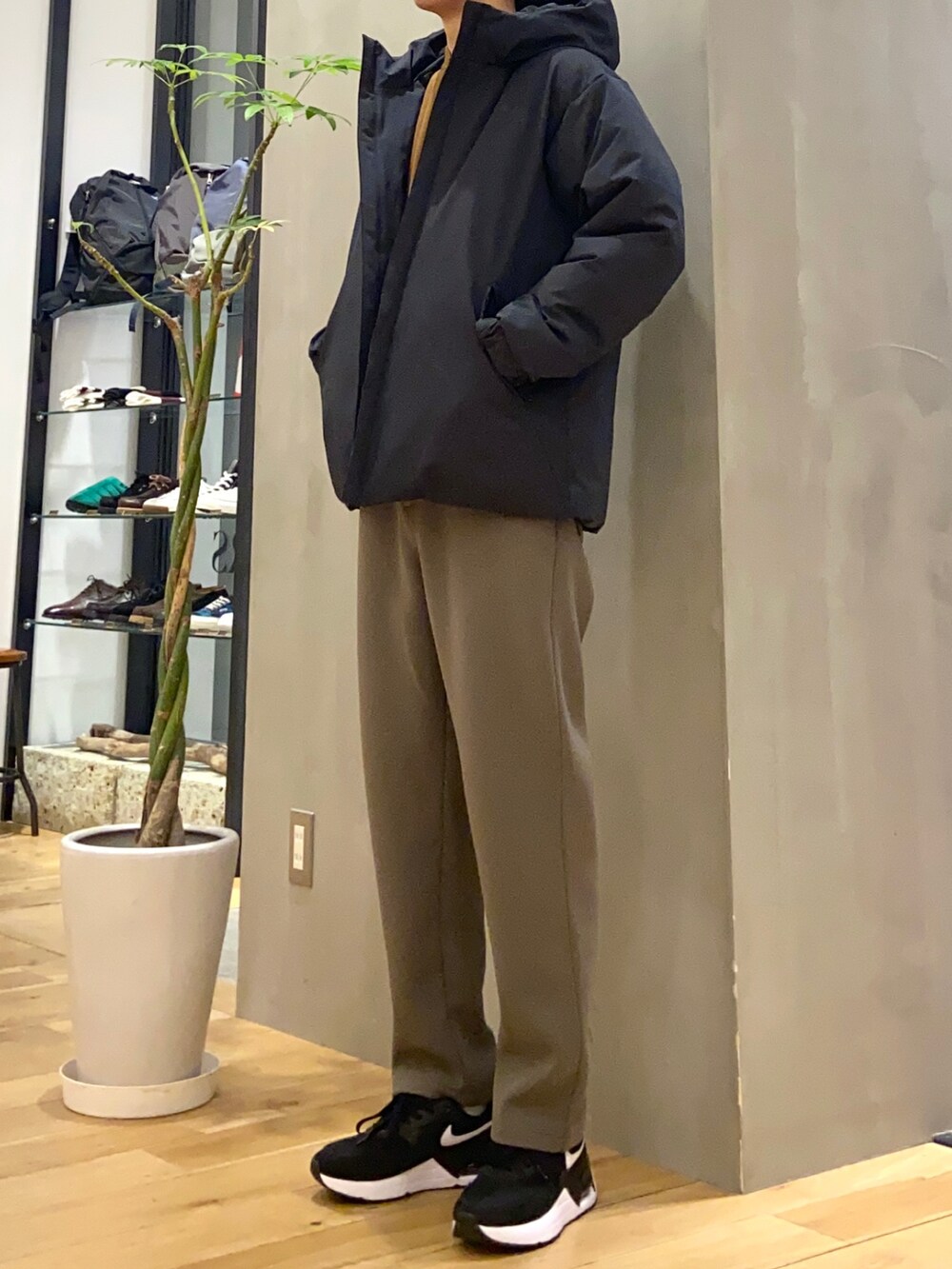 ブラック系のダウンジャケット/コート、ブラウン系のシャツ/ブラウス、グリーン系のその他パンツを着用したメンズの冬コーディネートの4枚目の写真