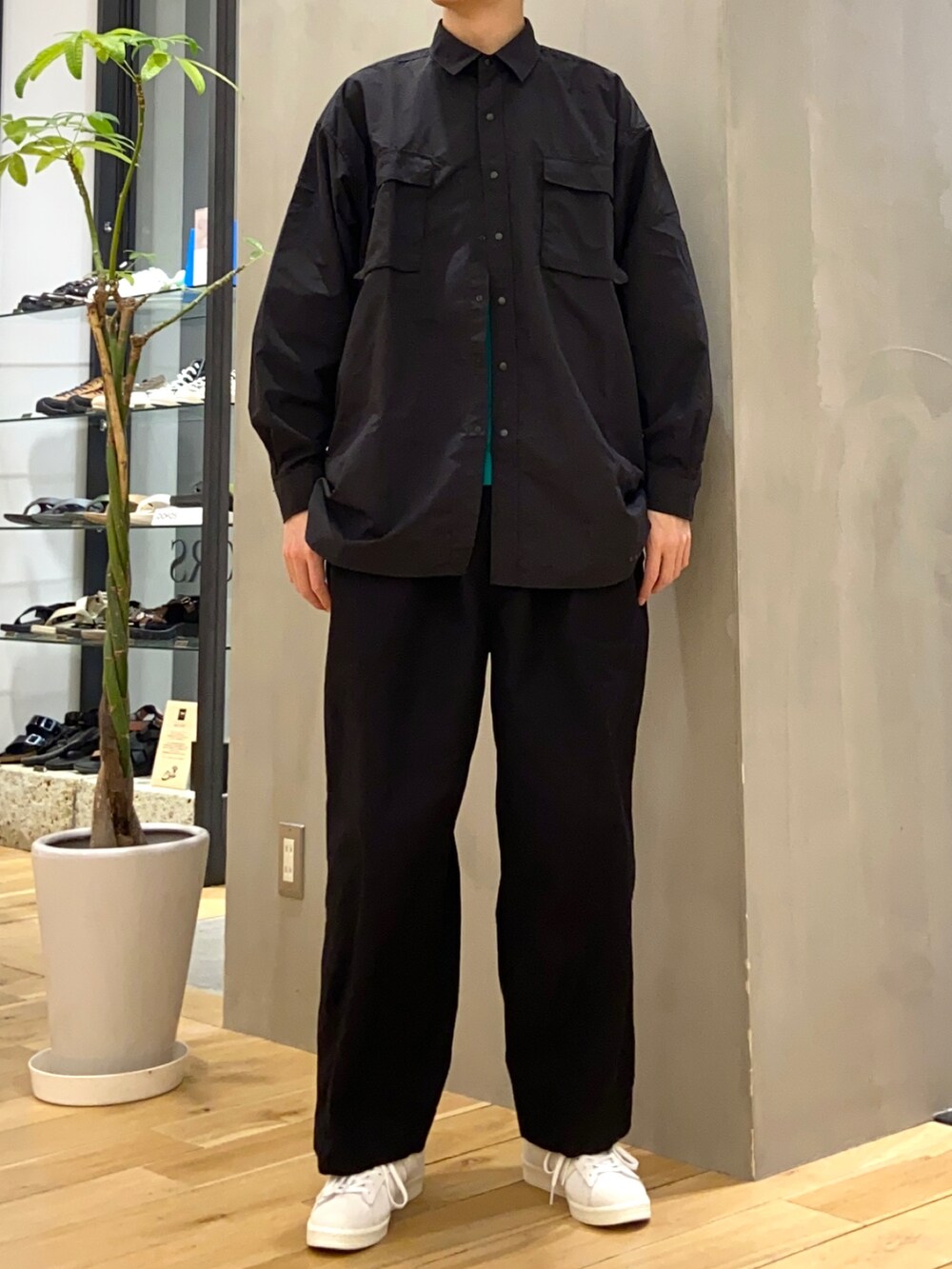 ブラック系のシャツ/ブラウス、グリーン系のTシャツ/カットソー、ベージュ系のスニーカーを着用したメンズの春コーディネートの3枚目の写真