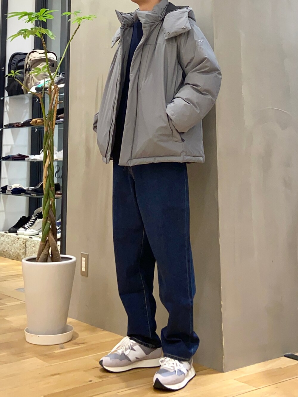 グレー系のダウンジャケット/コート、ブルー系のデニムパンツを着用したメンズの冬コーディネートの2枚目の写真