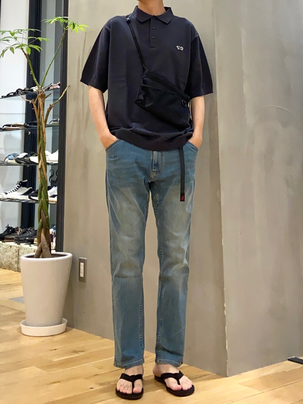 ブルー系のポロシャツ、ブルー系のその他パンツ、ブラック系のサンダルを着用したメンズの夏コーディネートの3枚目の写真