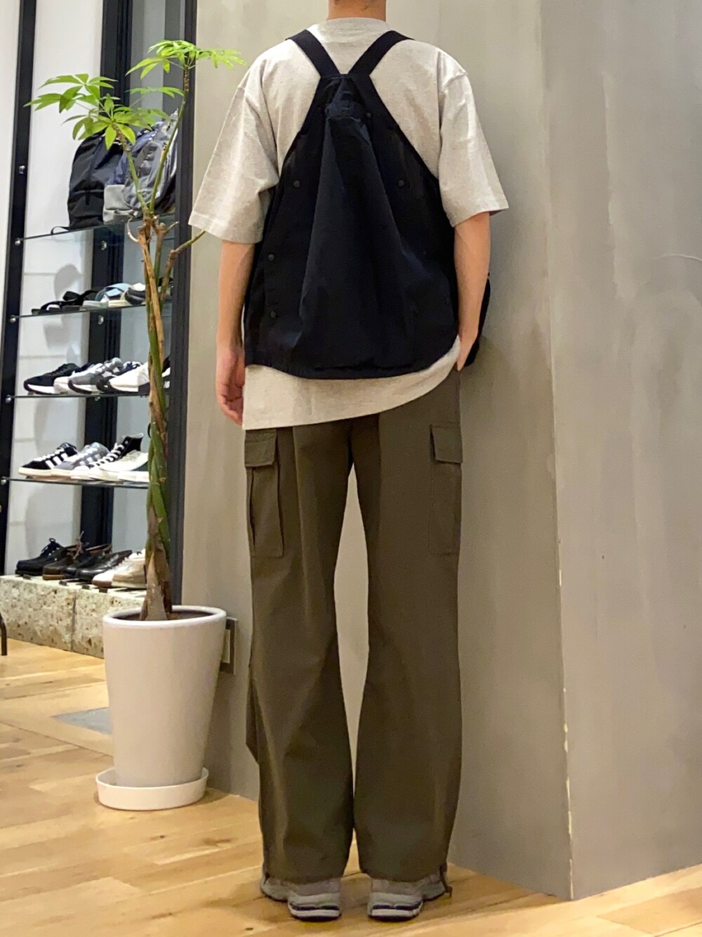 ブラック系のベスト、グリーン系のカーゴパンツを着用したメンズの春コーディネートの3枚目の写真