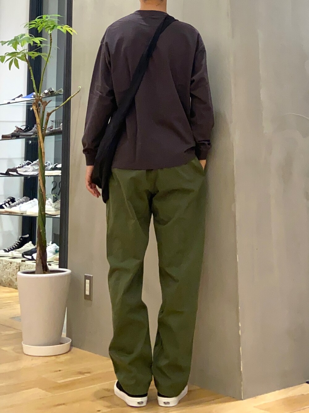 グレー系のTシャツ/カットソー、ブラック系のショルダーバッグ、ブラック系のスニーカーを着用したメンズの夏コーディネートの3枚目の写真