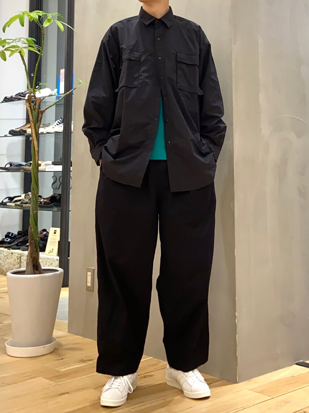 ブラック系のシャツ/ブラウス、グリーン系のTシャツ/カットソー、ベージュ系のスニーカーを着用したメンズの春コーディネートの4枚目の写真