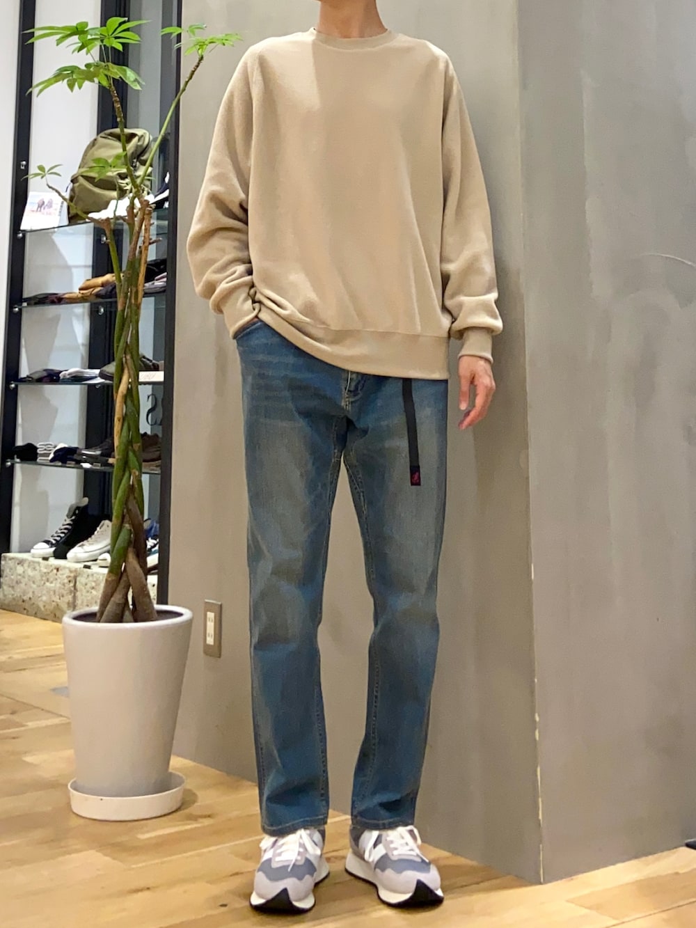 ブルー系のダウンジャケット/コート、ベージュ系のTシャツ/カットソー、ブルー系のその他パンツを着用したメンズの冬コーディネートの2枚目の写真