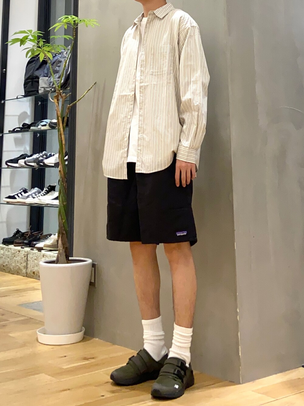 ベージュ系のシャツ/ブラウス、ブルー系のTシャツ/カットソー、グリーン系のスニーカーを着用したメンズの春コーディネートの3枚目の写真