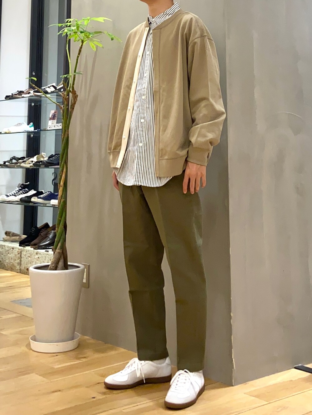 ベージュ系のカーディガン/ボレロ、グリーン系のシャツ/ブラウス、グリーン系のチノパンツを着用したメンズの秋コーディネートの2枚目の写真