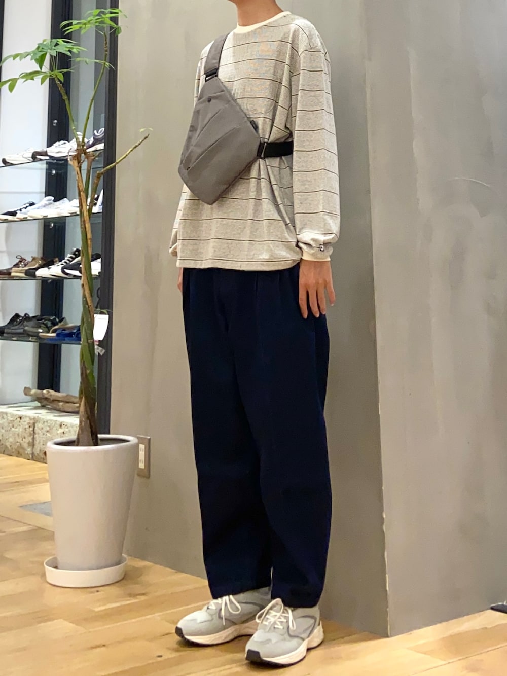 ホワイト系のTシャツ/カットソー、ベージュ系のショルダーバッグ、ブルー系のその他パンツを着用したメンズの秋コーディネートの2枚目の写真