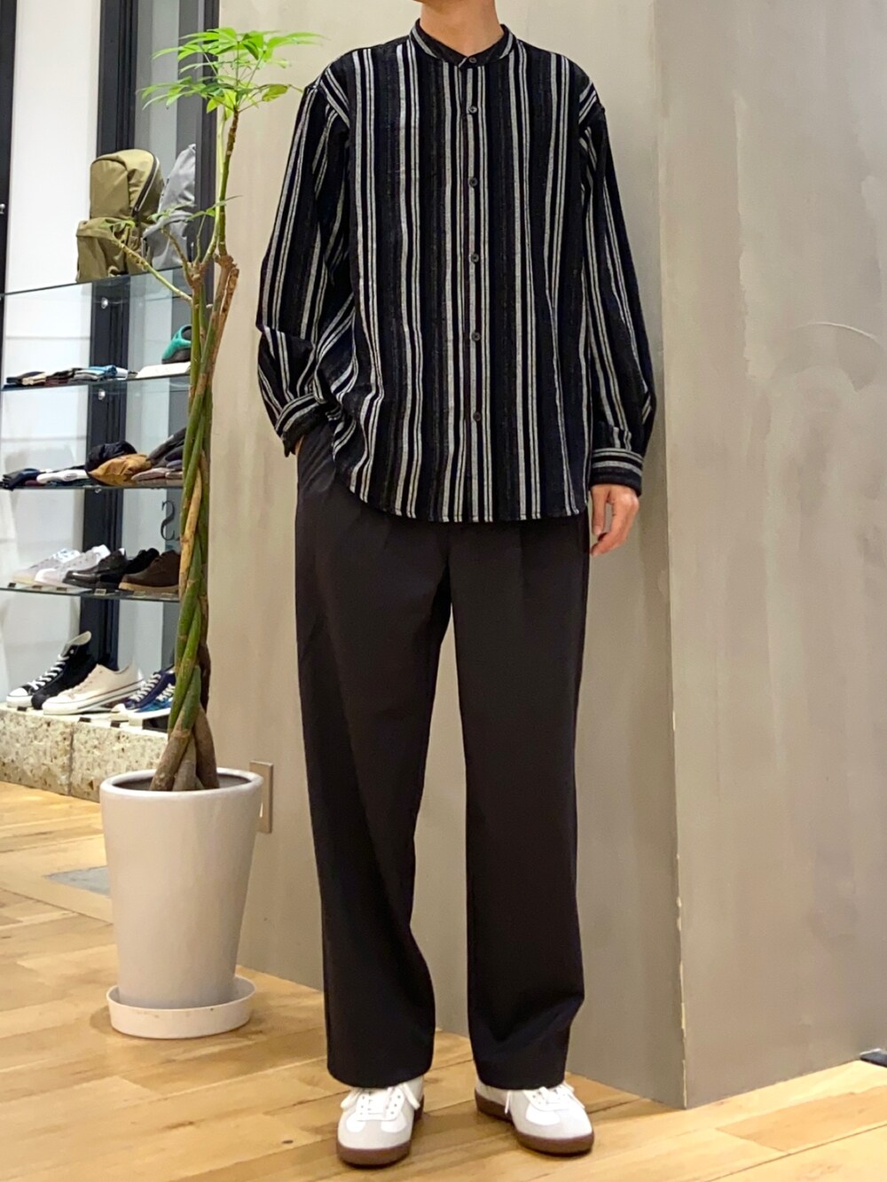 グレー系のカーディガン/ボレロ、ブラック系のシャツ/ブラウス、ホワイト系のスニーカーを着用したメンズの秋コーディネートの3枚目の写真