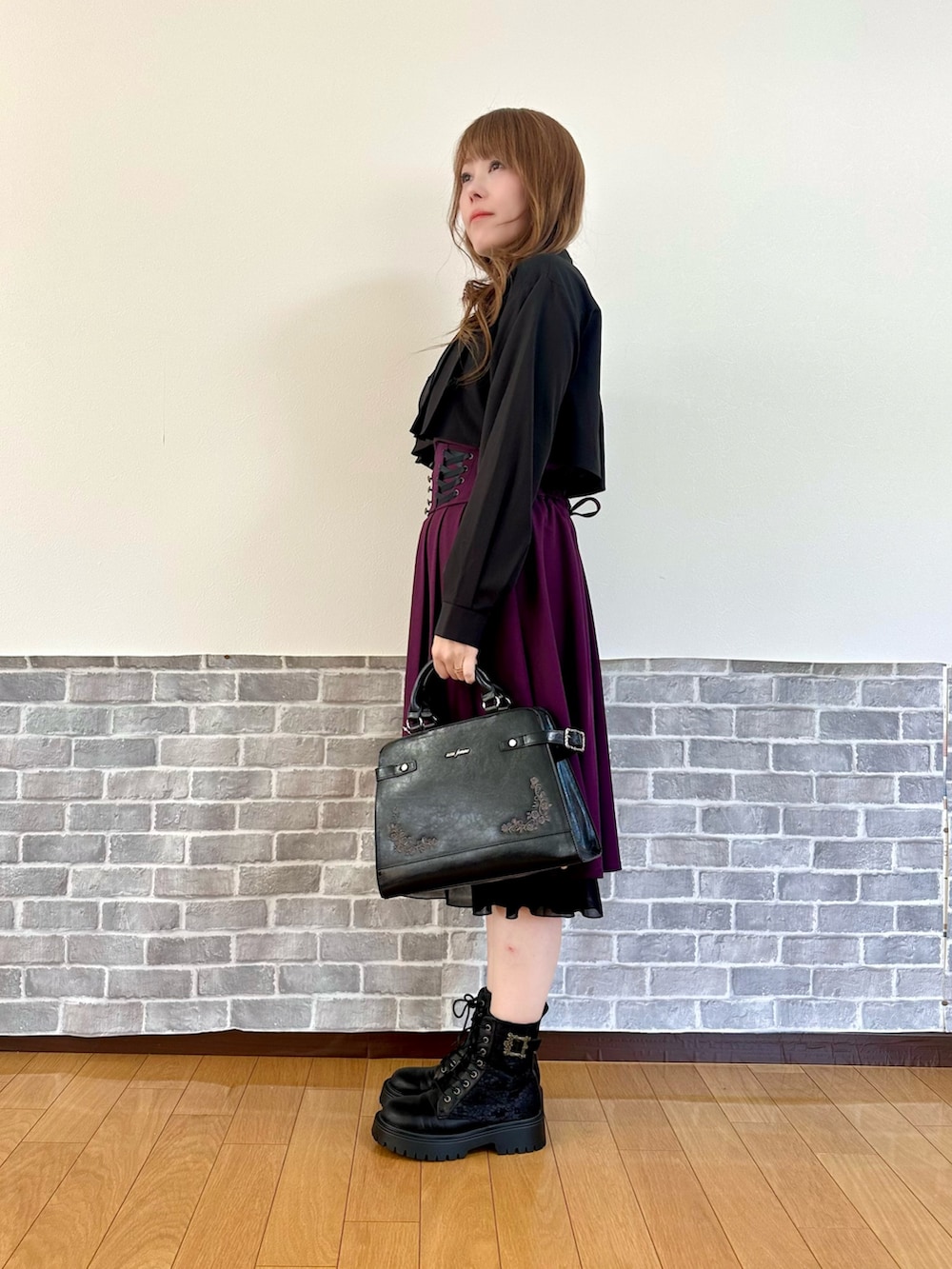 ブラック系のシャツ/ブラウス、ブラック系のカーディガン/ボレロ、パープル系のスカートを着用したレディースの秋コーディネートの3枚目の写真