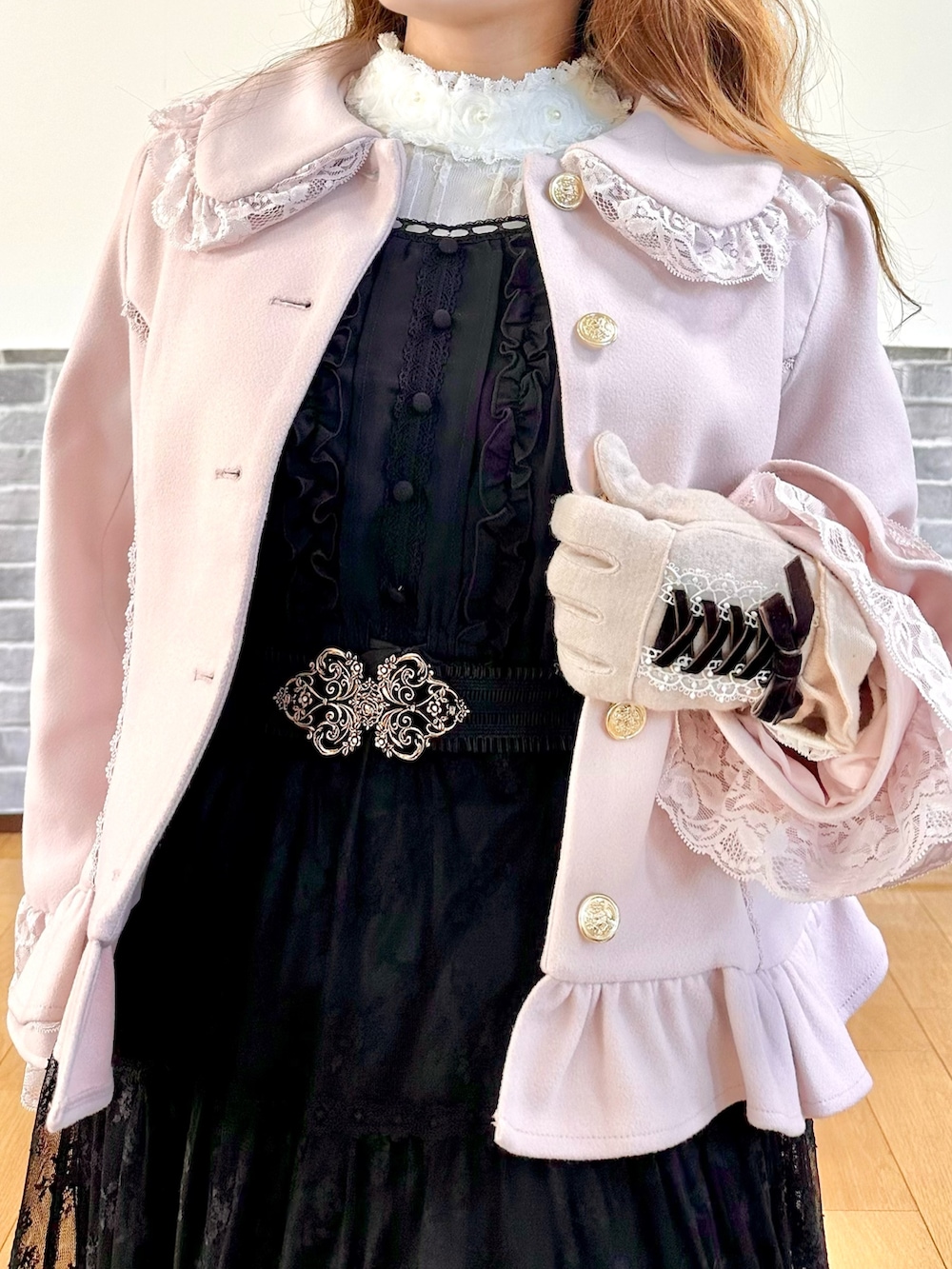 ピンク系のピーコート、ブラック系のスカート、ブラック系のボストンバッグを着用したレディースの秋コーディネートの7枚目の写真