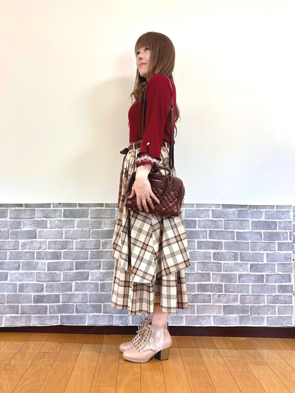 ホワイト系のタンクトップ、レッド系のTシャツ/カットソー、ブラウン系のボストンバッグを着用したレディースの秋コーディネートの2枚目の写真