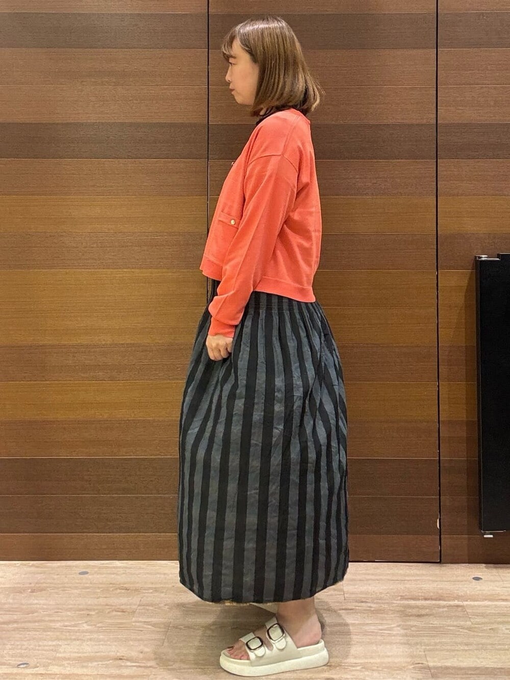 ブラック系のTシャツ/カットソー、ベージュ系のスカート、ベージュ系のショルダーバッグを着用したレディースの夏コーディネートの5枚目の写真