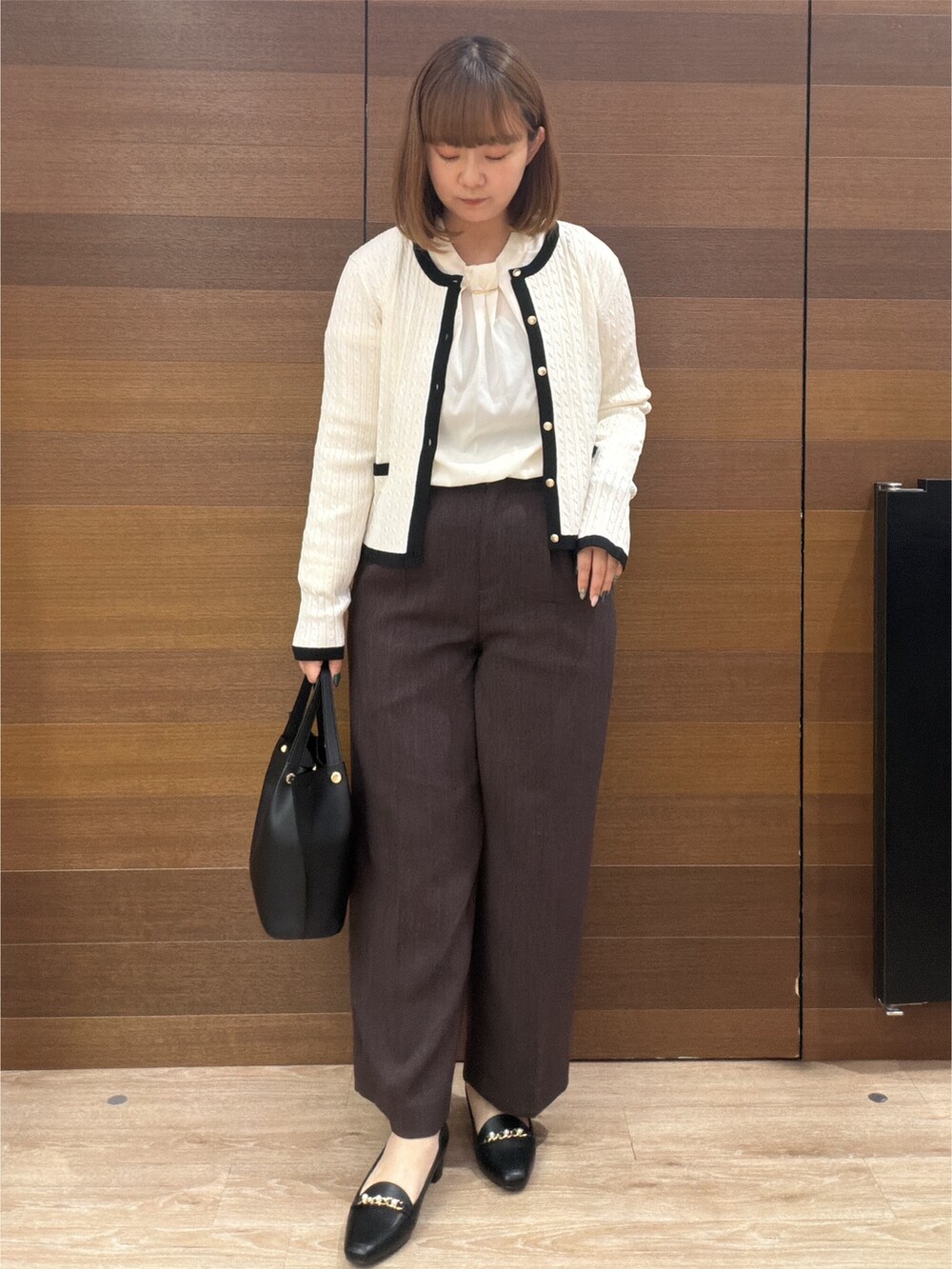 ホワイト系のカーディガン/ボレロ、ホワイト系のシャツ/ブラウス、ブラウン系のその他パンツを着用したレディースの秋コーディネートの3枚目の写真