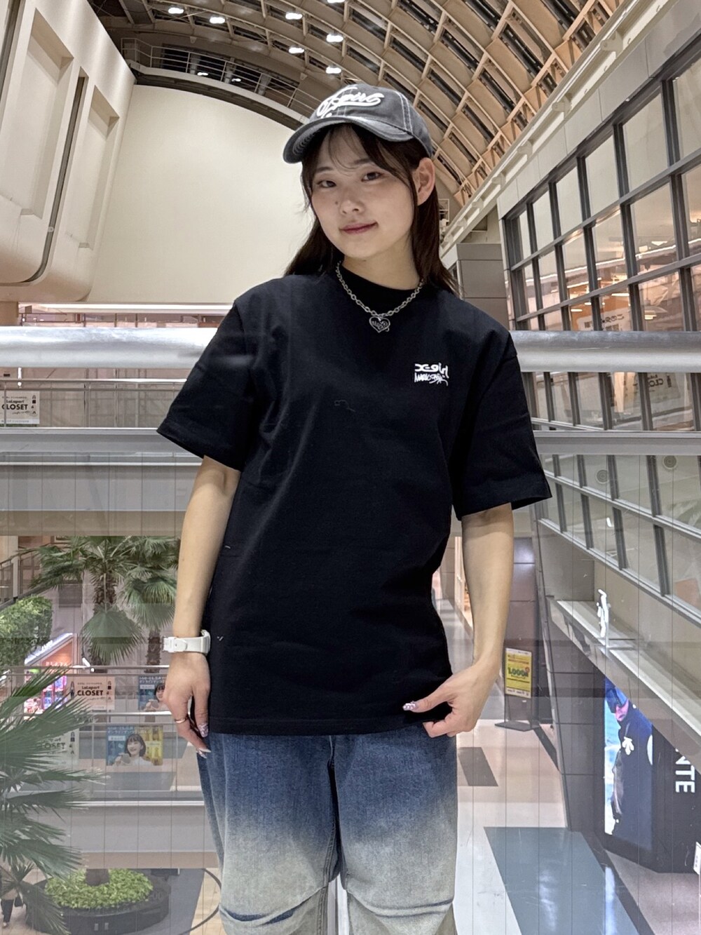 ブラック系のTシャツ/カットソー、グレー系のニット/セーター、ブルー系のデニムパンツを着用したレディースの冬コーディネートの4枚目の写真