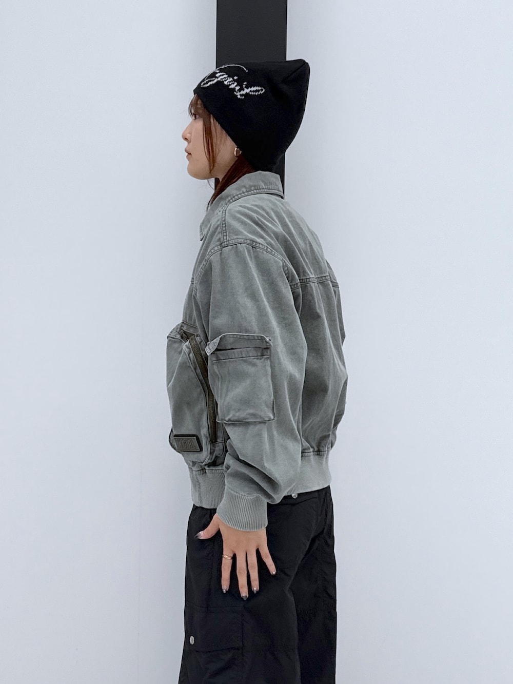 ブラック系のカーゴパンツ、ゴールド系のハンドバッグ、ブラック系のTシャツ/カットソーを着用したレディースの秋コーディネートの5枚目の写真