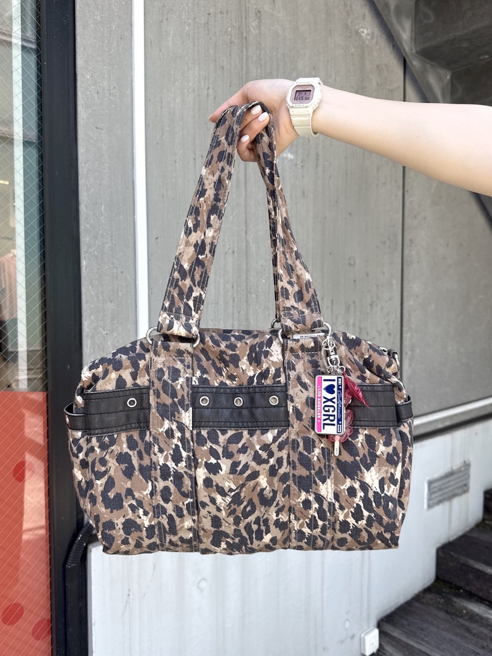 ピンク系のタンクトップ、ホワイト系のポロシャツ、ブラック系のスウェットパンツを着用したレディースの夏コーディネートの7枚目の写真