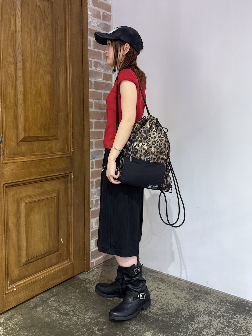 ブラック系のその他パンツ、ベージュ系のバックパック/リュック、レッド系のTシャツ/カットソーを着用したレディースの夏コーディネートの2枚目の写真