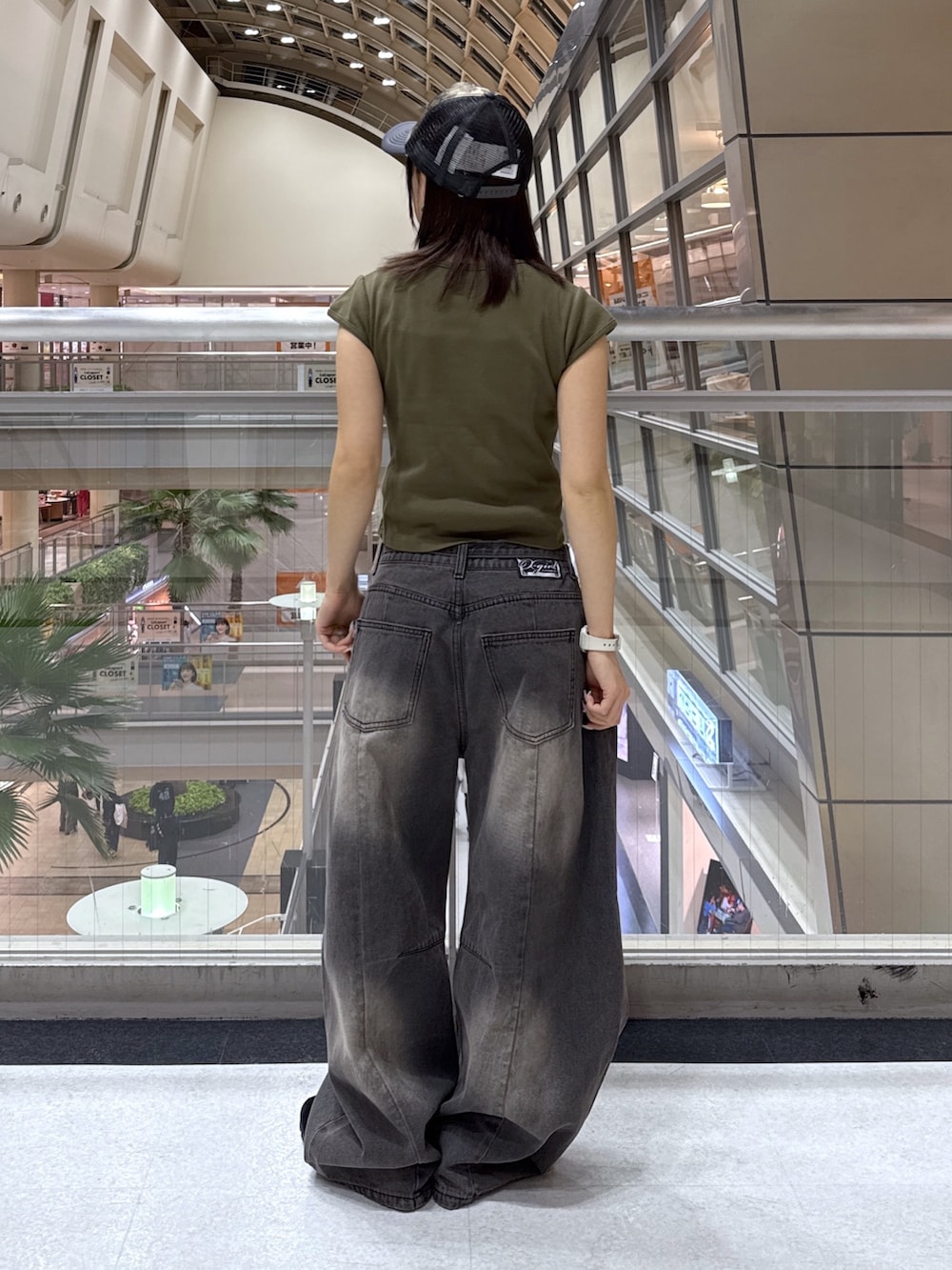 グリーン系のTシャツ/カットソー、ブラック系のショルダーバッグ、ホワイト系のシャツ/ブラウスを着用したレディースの冬コーディネートの6枚目の写真