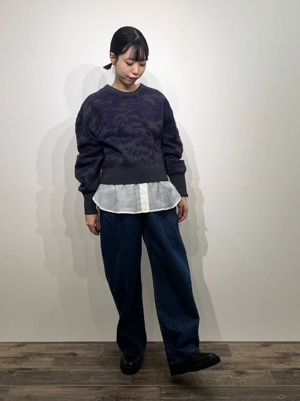 ブルー系のデニムパンツ、ブラック系のブーツ、ホワイト系のシャツ/ブラウスを着用したレディースの冬コーディネートの3枚目の写真