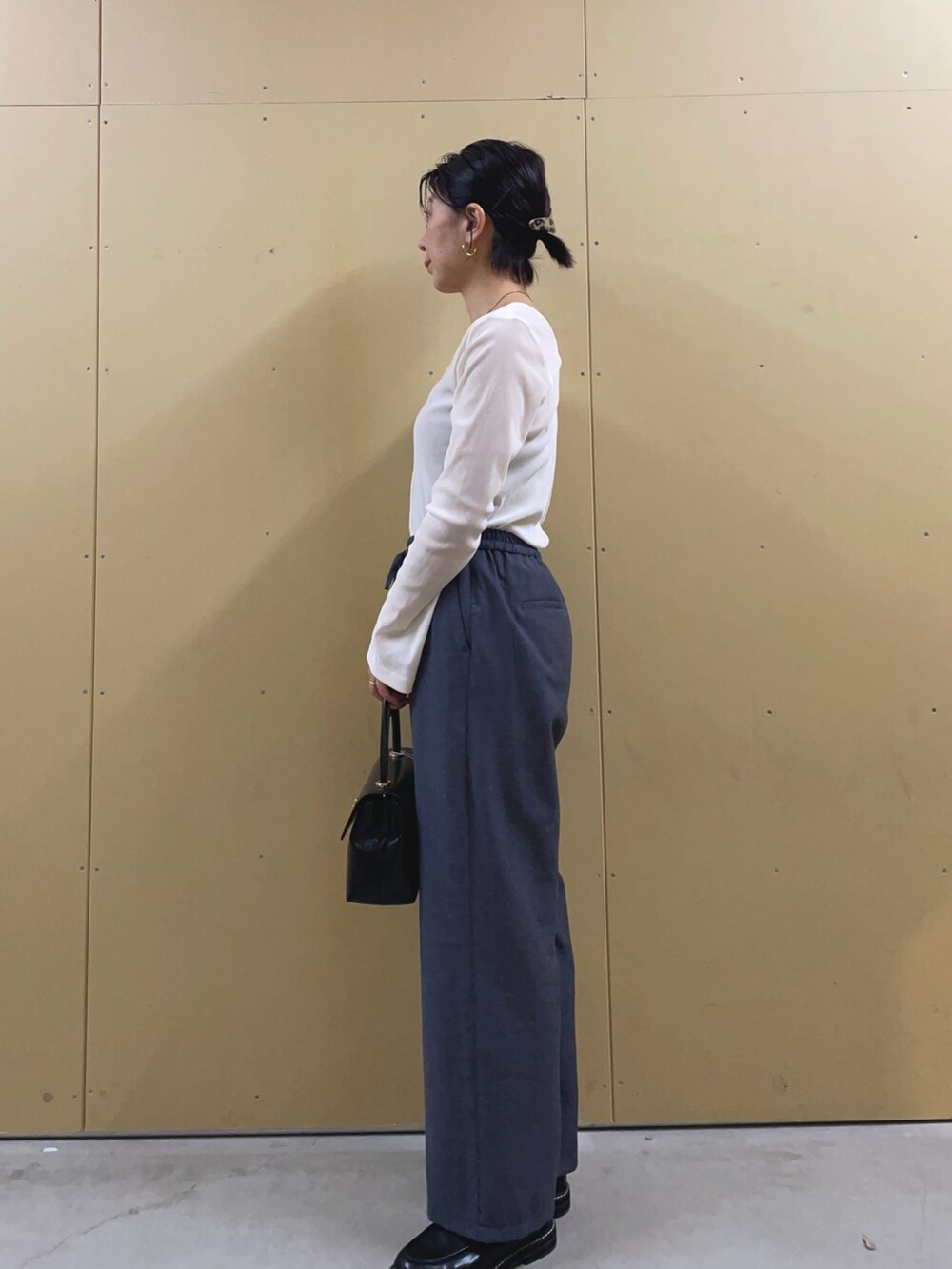 ブラック系のショルダーバッグ、ブルー系のその他パンツ、ブラック系のその他シューズを着用したレディースの春コーディネートの3枚目の写真