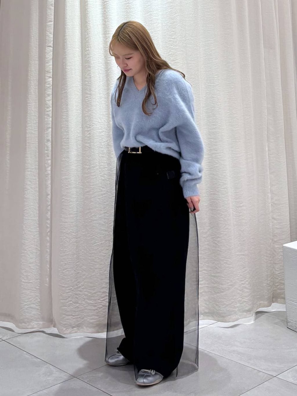 ブルー系のニット/セーター、シルバー系のスニーカー、ブラック系のその他パンツを着用したレディースの秋コーディネートの3枚目の写真