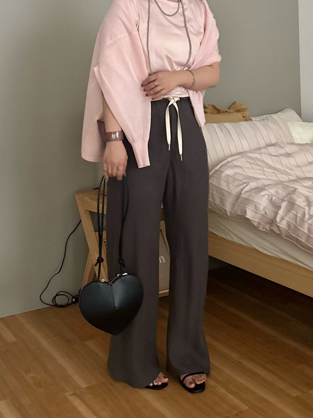 グレー系のその他パンツ、ブラック系のショルダーバッグ、ピンク系のTシャツ/カットソーを着用したレディースの夏コーディネートの2枚目の写真