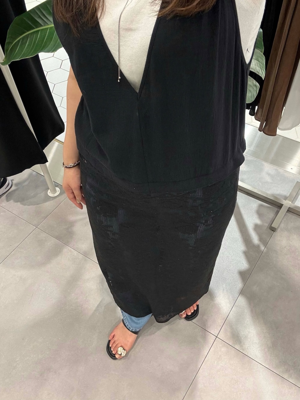 ホワイト系のタンクトップ、ブラック系のワンピース、ブラック系のサンダルを着用したレディースの春コーディネートの2枚目の写真