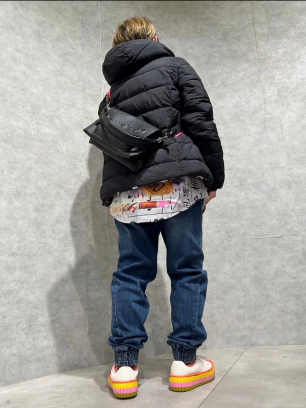 ブラック系のダウンジャケット/コート、ブラック系のボディバッグ/ウエストポーチ、ホワイト系のシャツ/ブラウスを着用したレディースの秋コーディネートの2枚目の写真